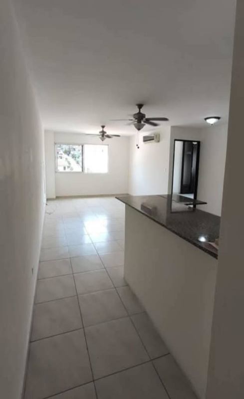 Bright living room with tile flooring and ceiling fans in Condado del Rey Panama