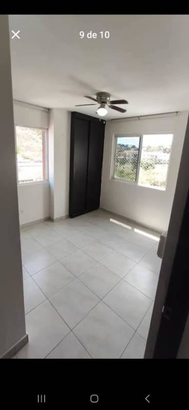 Modern bedroom with large windows, wardrobe, ceiling fan Condado del Rey Panama