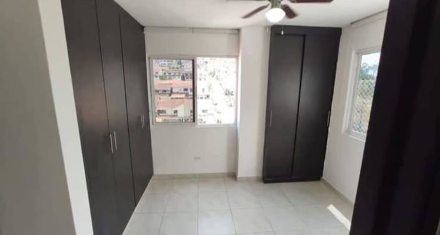 Bedroom featuring built-in wardrobe and tile flooring Altos de Santa María Panama