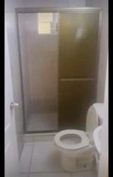 Bathroom with sliding glass shower doors, pedestal sink and ceramic tiles in PH Sausalito Gardens La Chorrera Panama Oeste