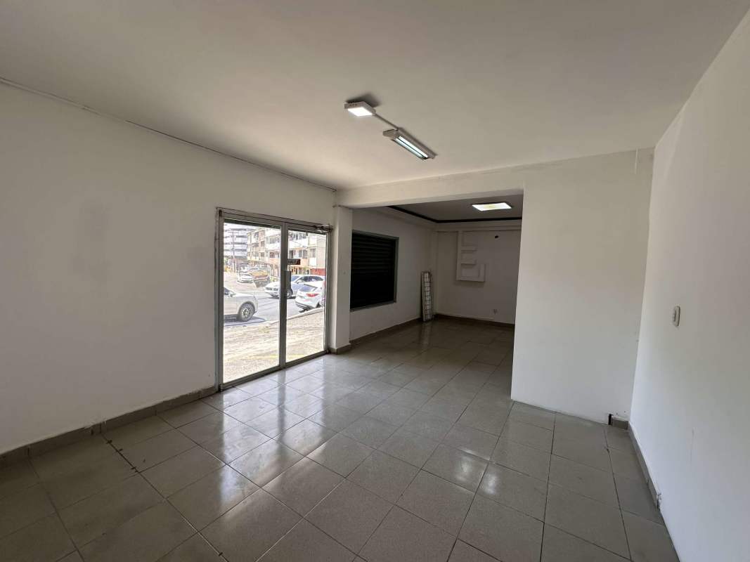 Glass door entrance of retail commercial space with parking front Carrasquilla Panama