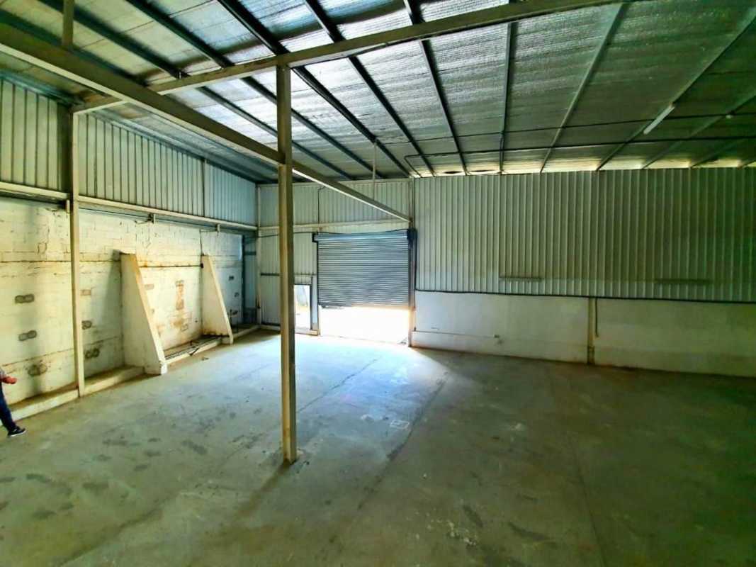 Industrial warehouse with metal walls large shutter door concrete floors Panama City