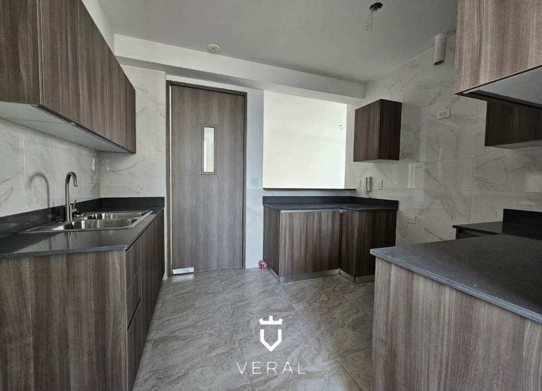 Modern kitchen with wood cabinets and marble tile walls PH Luxor 400 El Cangrejo Panama