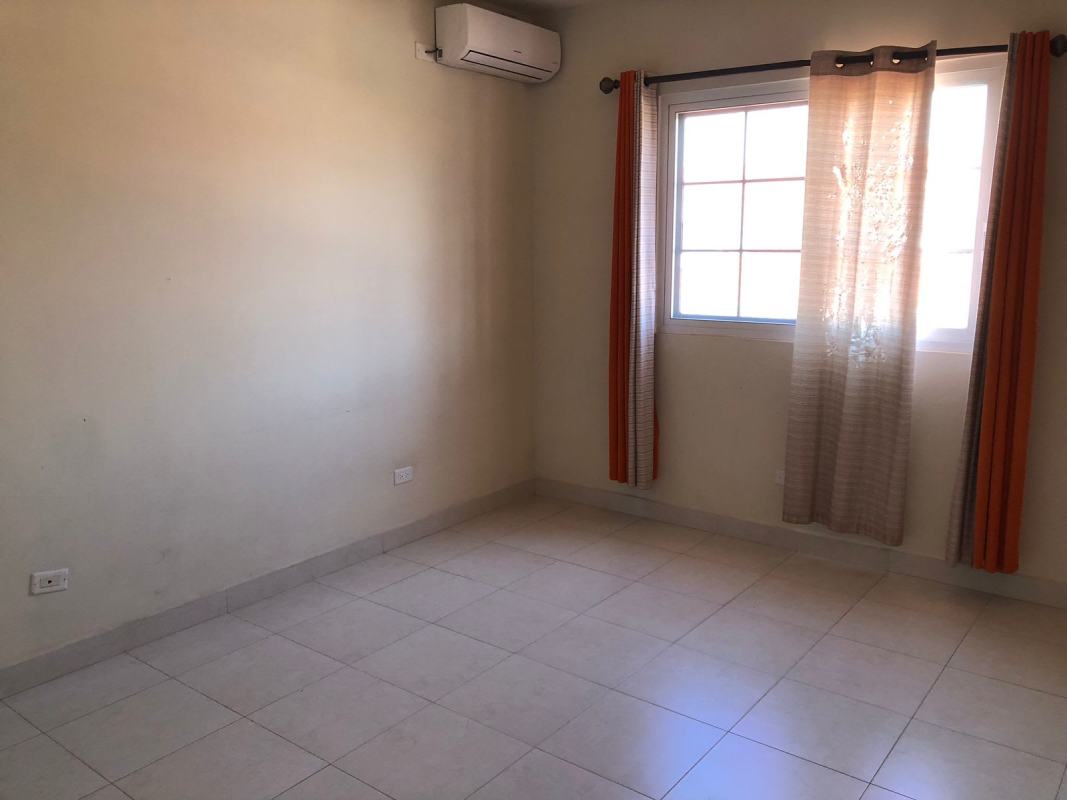 Secondary bedroom with ceramic tile flooring and window in Versalles home for sale Panama City