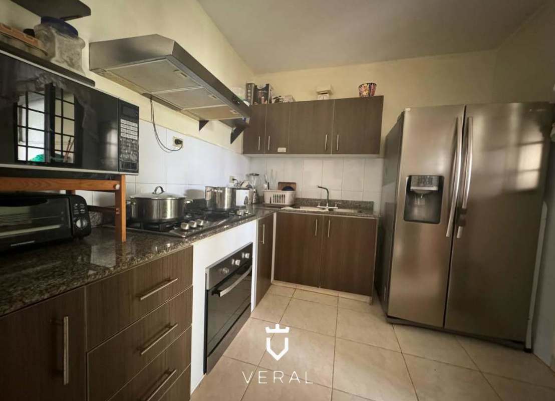 Spacious kitchen with granite countertops, wooden cabinets, stainless appliances in Panama Norte House for sale