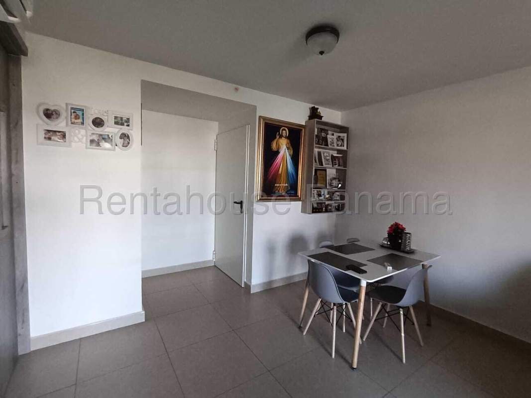 Kitchen with granite counters, stove, oven, fridge, and modern cabinets in Costa Sur Panama apartment