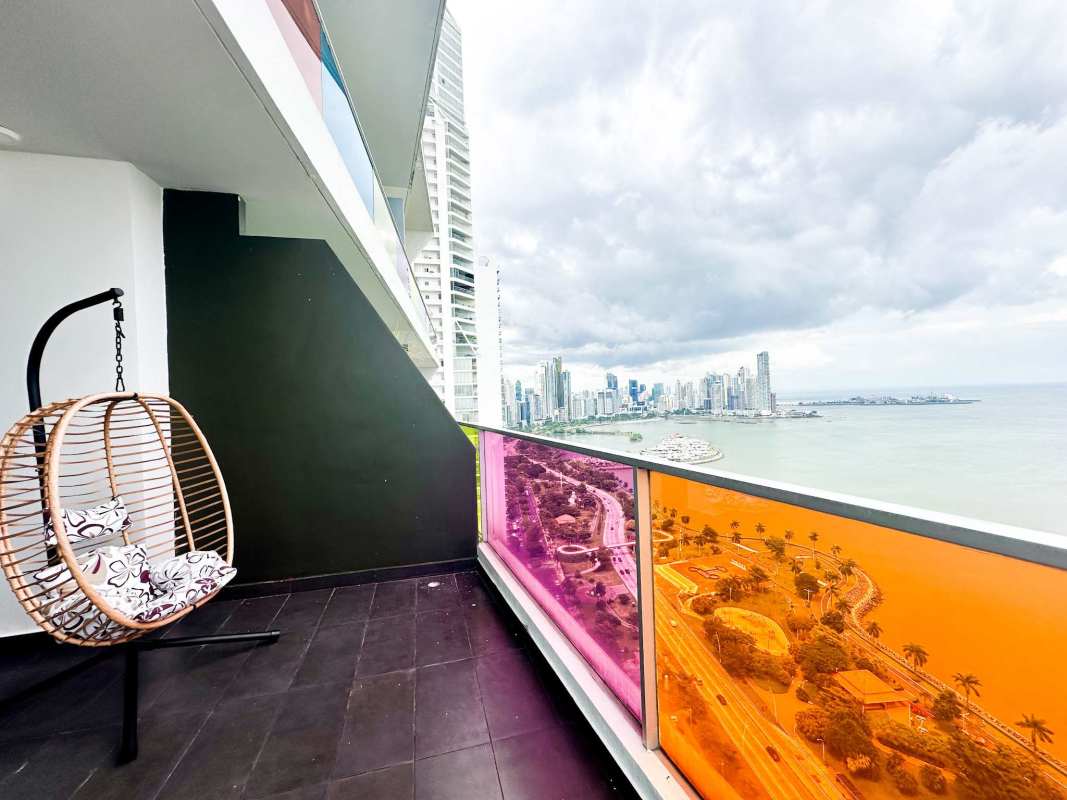 Bright open living and dining with floor-to-ceiling windows ocean views Avenida Balboa Panama
