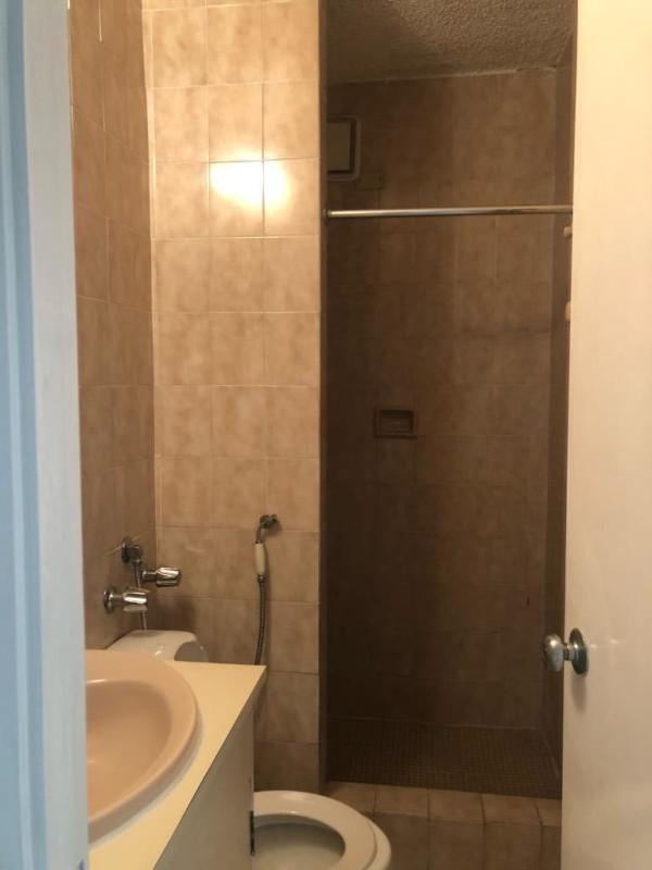 Bathroom with beige tile and shower in rental apartment PH Punta Paitilla Panama