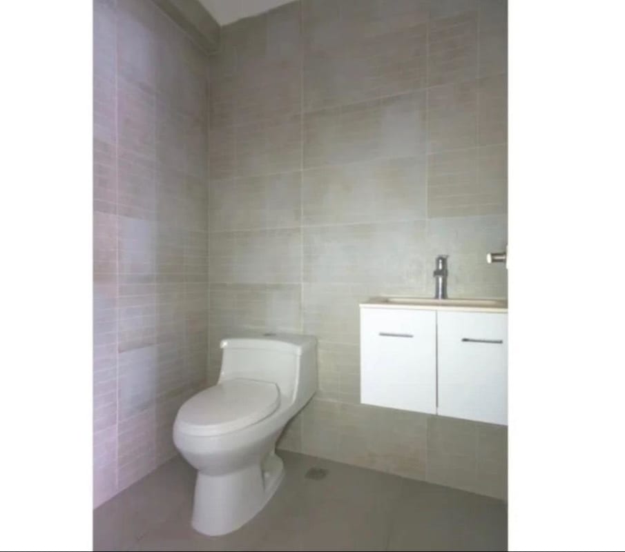 Spacious master bedroom with built-in closets and floor-to-ceiling windows overlooking Panama City skyline