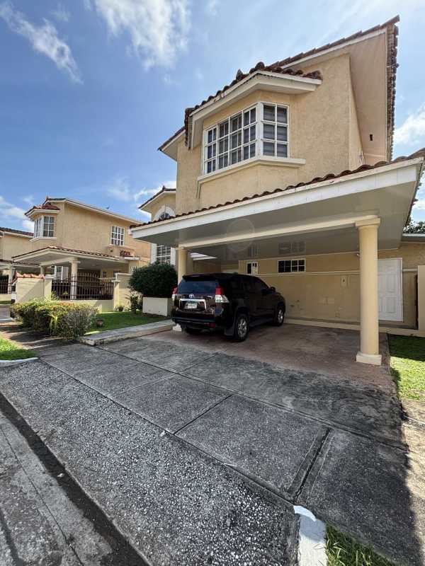 Exterior front view Mediterranean style house with carport, bay windows, tiled roof in Clayton Estates Panama City