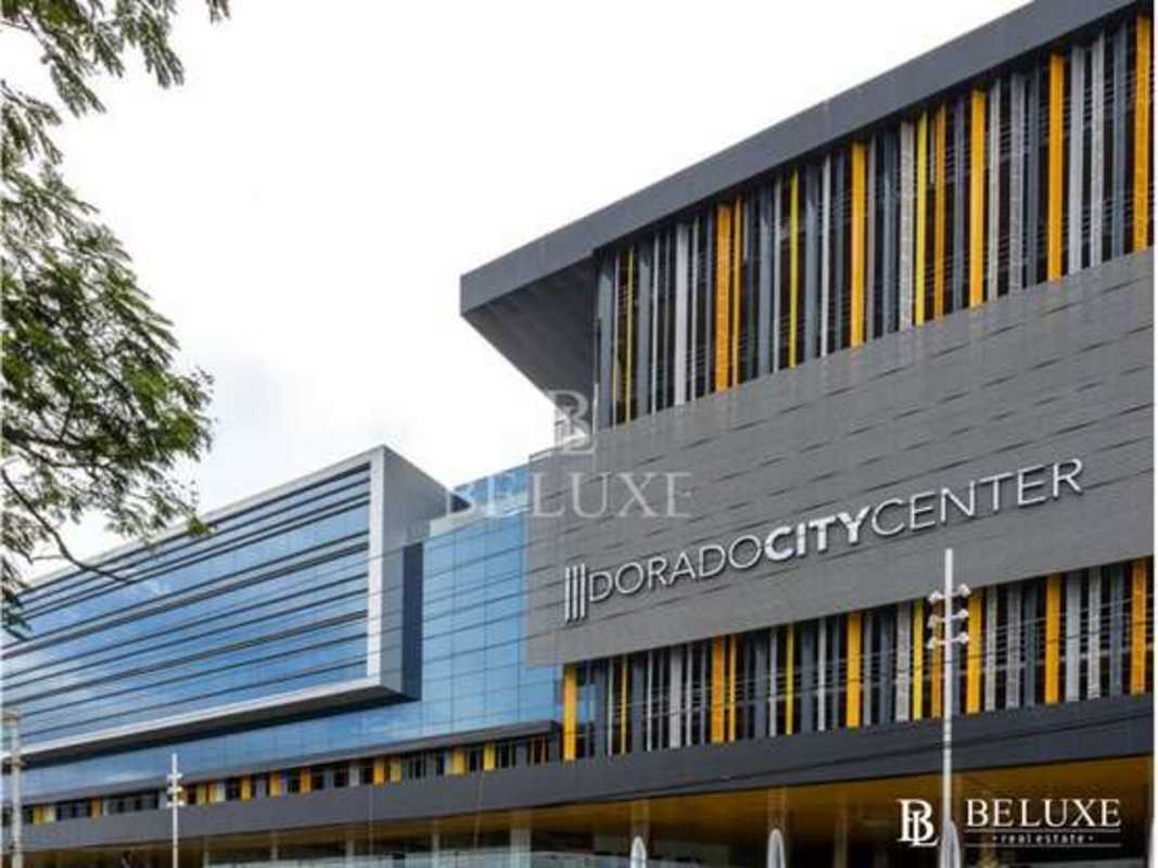 Street view of Dorado City Center modern commercial complex with glass walls and colorful accents in Panama City