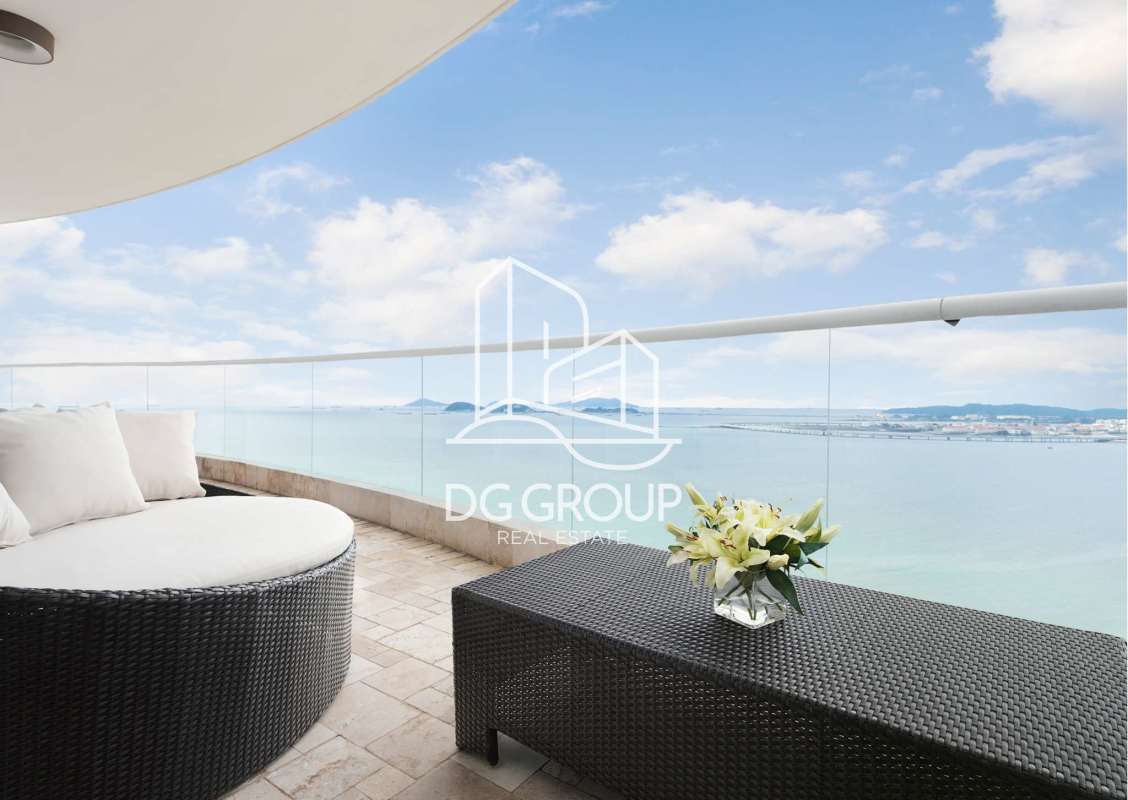 Modern balcony with ocean skyline panorama furnished with daybed and coffee table at PH The Point Panama City