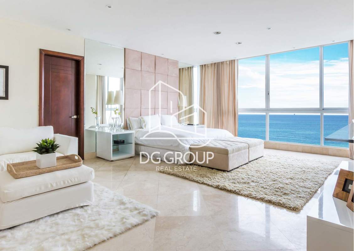 Luxurious master bedroom with ocean views, marble tile, and floor-to-ceiling windows in PH The Point Panama City