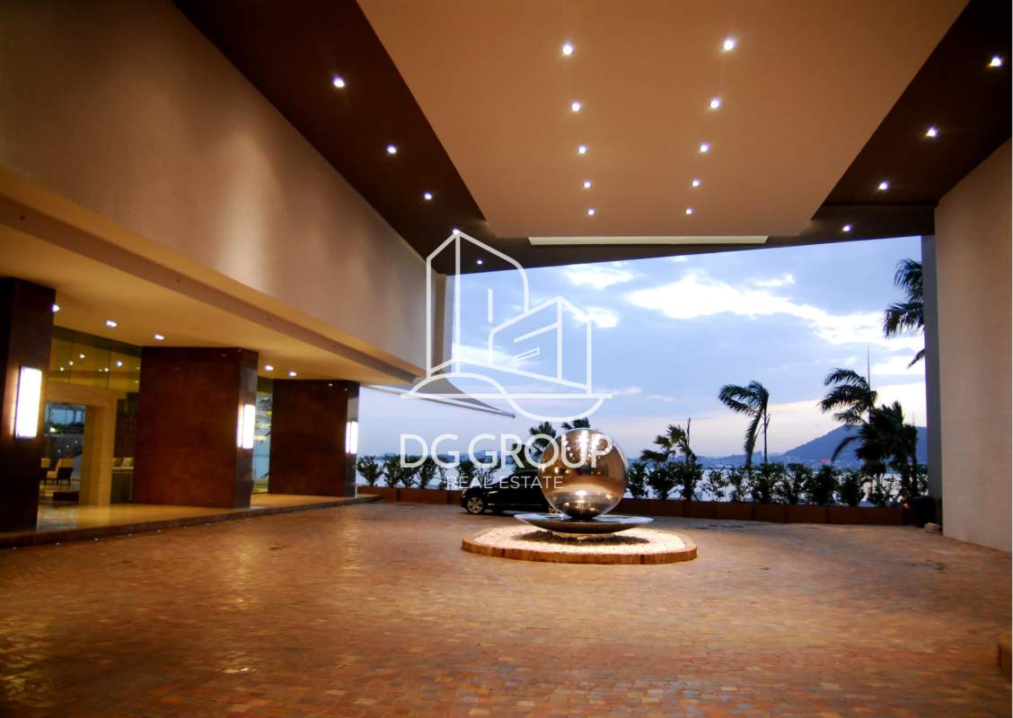 Grand lobby entrance of PH The Point with modern sculpture and water features in Panama City