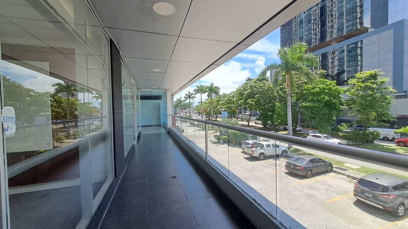 Exterior corridor with glass railing overlooking Costa del Este business district