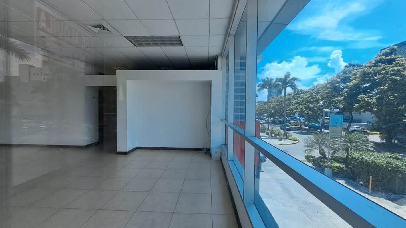 Empty commercial interior with large windows facing trees in PH Green Plaza