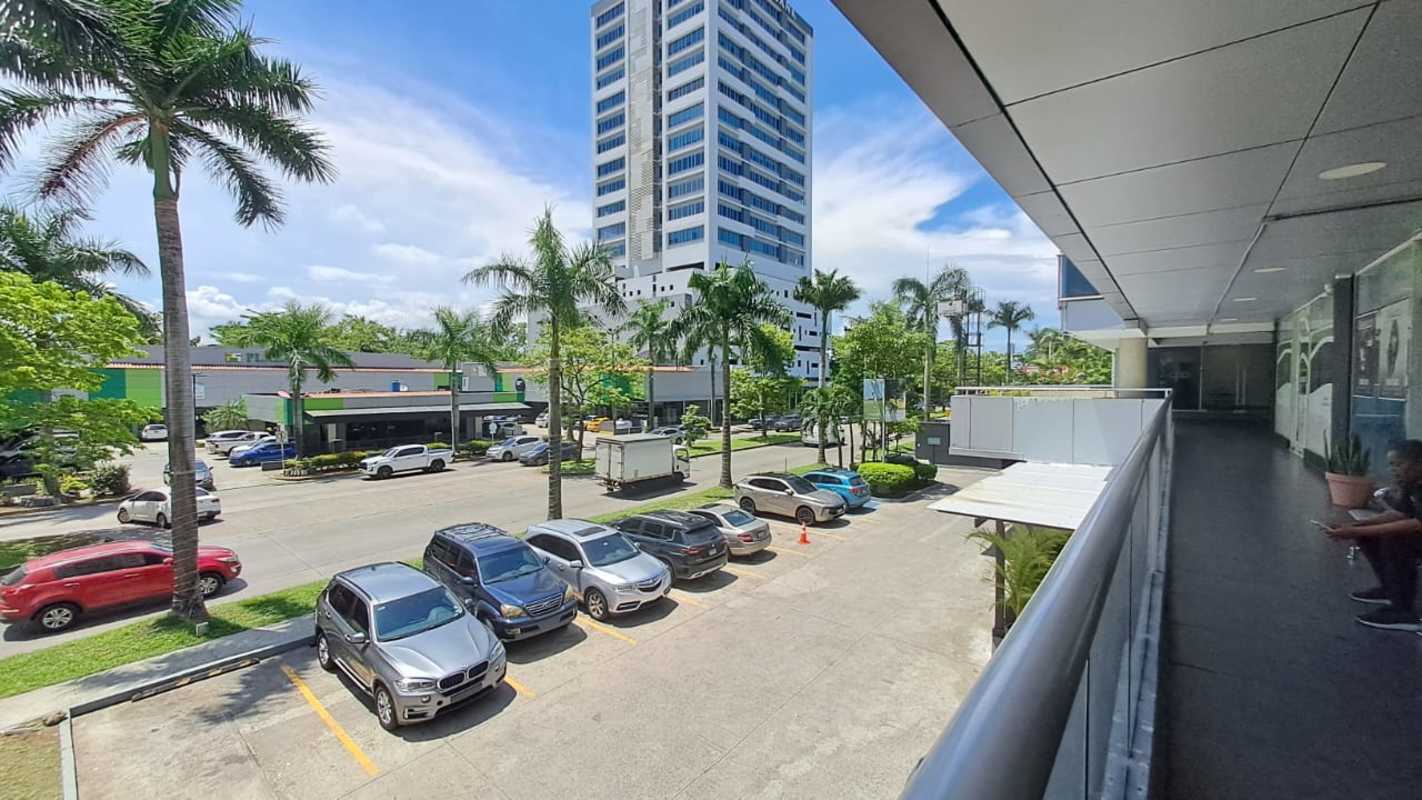 Contemporary commercial tower with parking and palm trees in Costa del Este