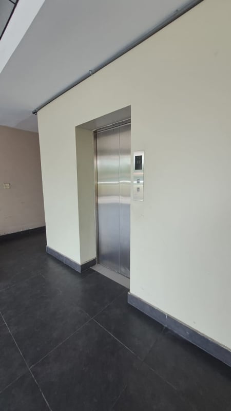 Modern elevator lobby with stainless steel doors inside PH Green Plaza Costa del Este