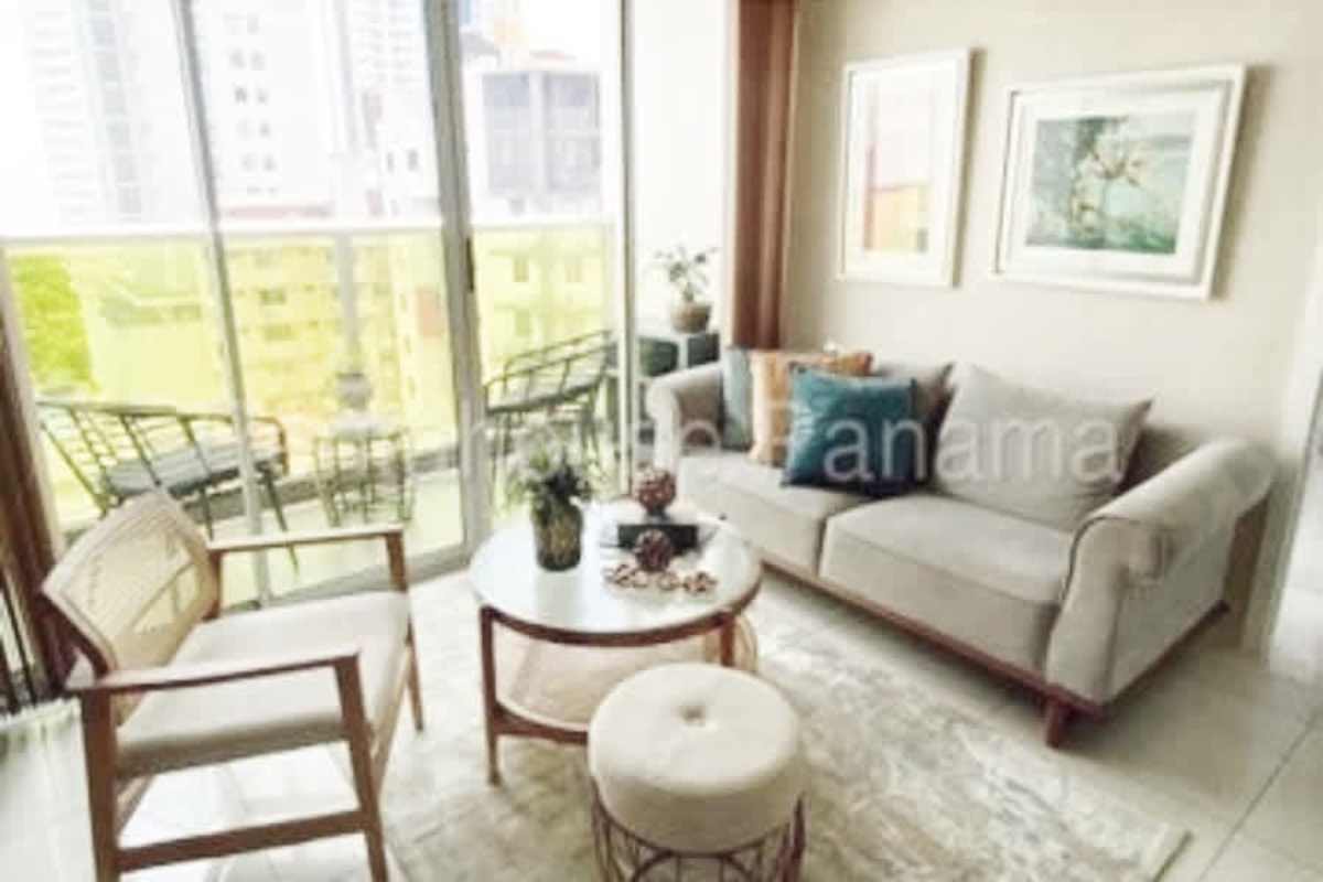 Modern bright living room with large glass doors leading to balcony PH Coco del Mar Panama