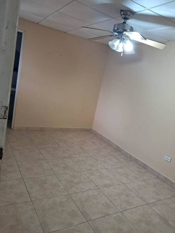 Bedroom with ceramic tile, beige walls, ceiling fan affordable house rental Pacora Panama