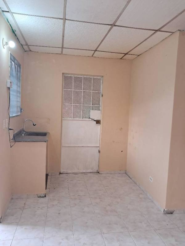 Compact kitchen with single sink, tile counters and security window rental home Panama City