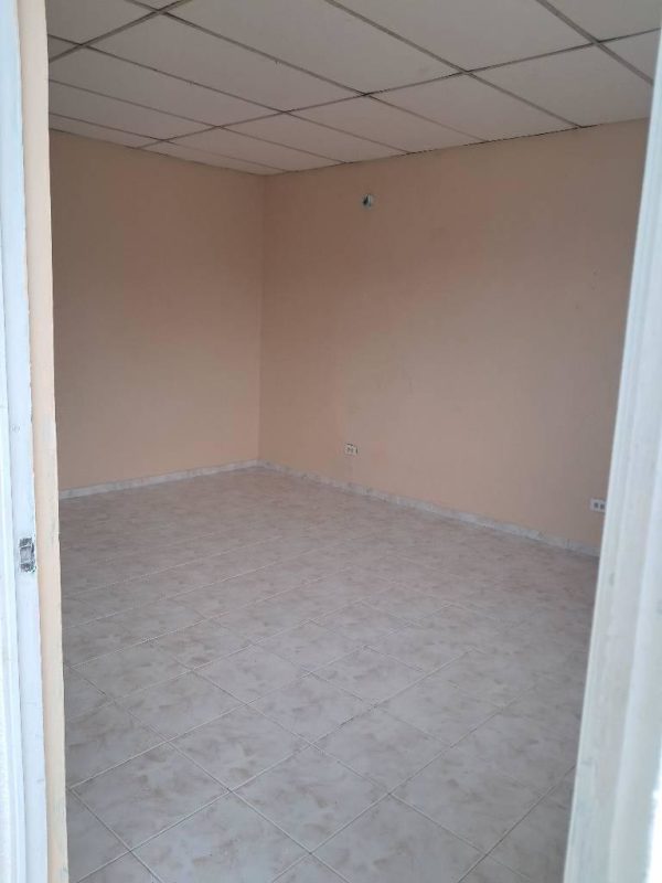 Unfurnished beige tiled room inside budget rental home Pacora Panama City