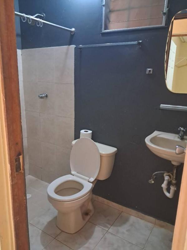 Basic tiled bathroom with shower dark beige walls rental house in Pacora Panama