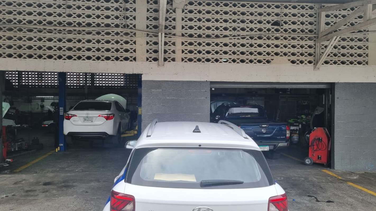 Industrial warehouse interior workshop bays with vehicle lifts and tools in Parque Lefevre Panama