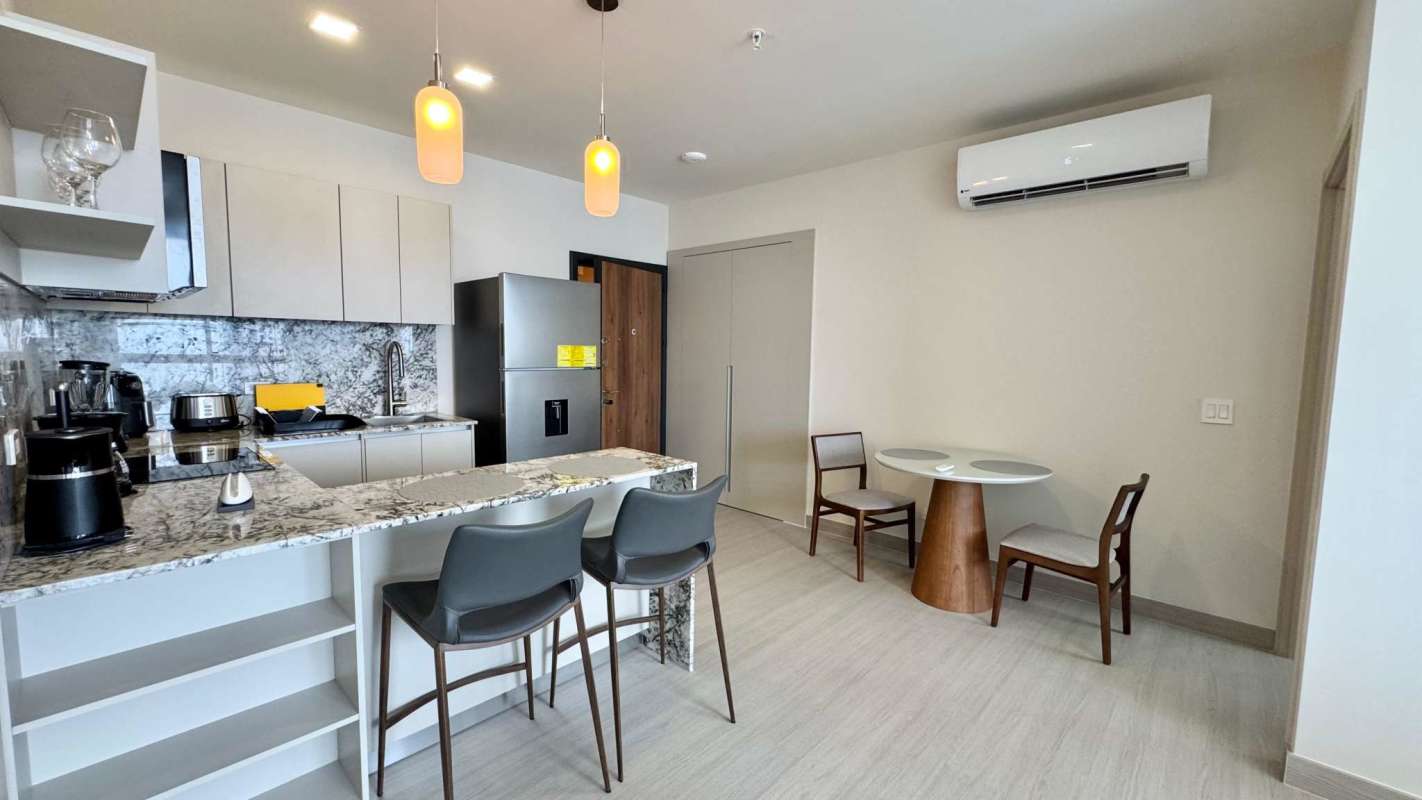 Granite countertop kitchen with full appliances and open design in PH Arcadia Tower Costa del Este