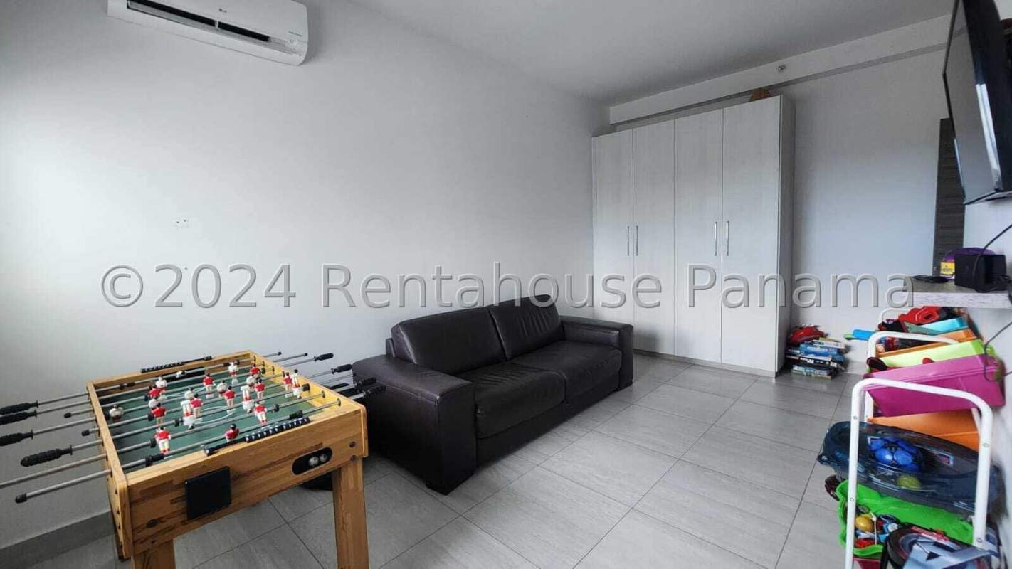 Modern open living and dining room with blue chairs, marble coffee table, large windows in PH Parkview Costa del Este Panama City