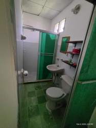 Compact green tile bathroom with glass shower enclosure Coclé Panama Carnival house rental