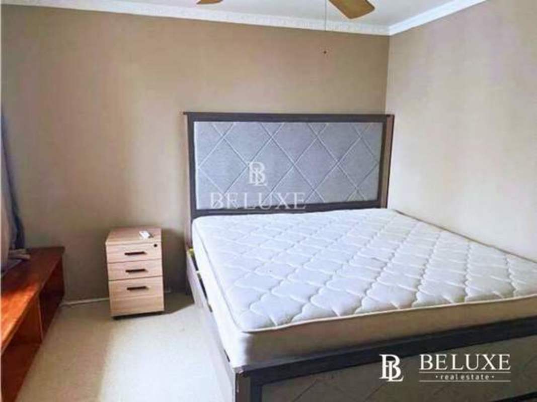 Bedroom with large window and city view in PH Marsella, Marbella Panama City