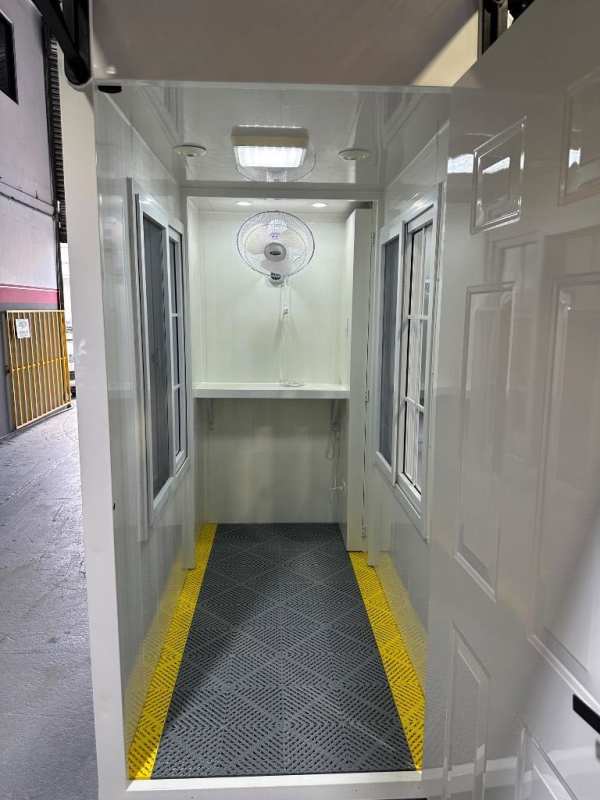 Compact interior with counter, fans, sliding windows in portable booth Costa del Este Panama