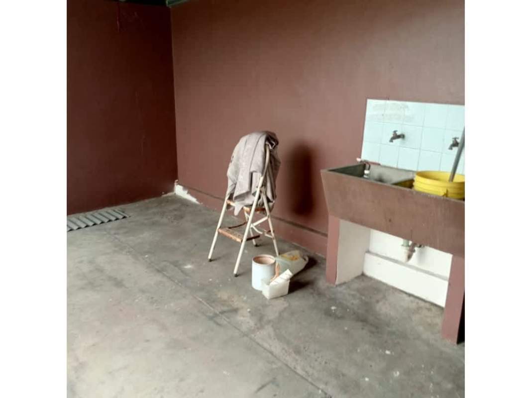 Utility and laundry room with sink, brown walls in Bethania rental house Panama