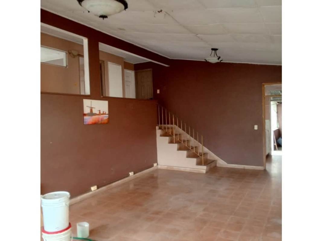 Large living room space with stairs brown walls Bethania house for rent Panama