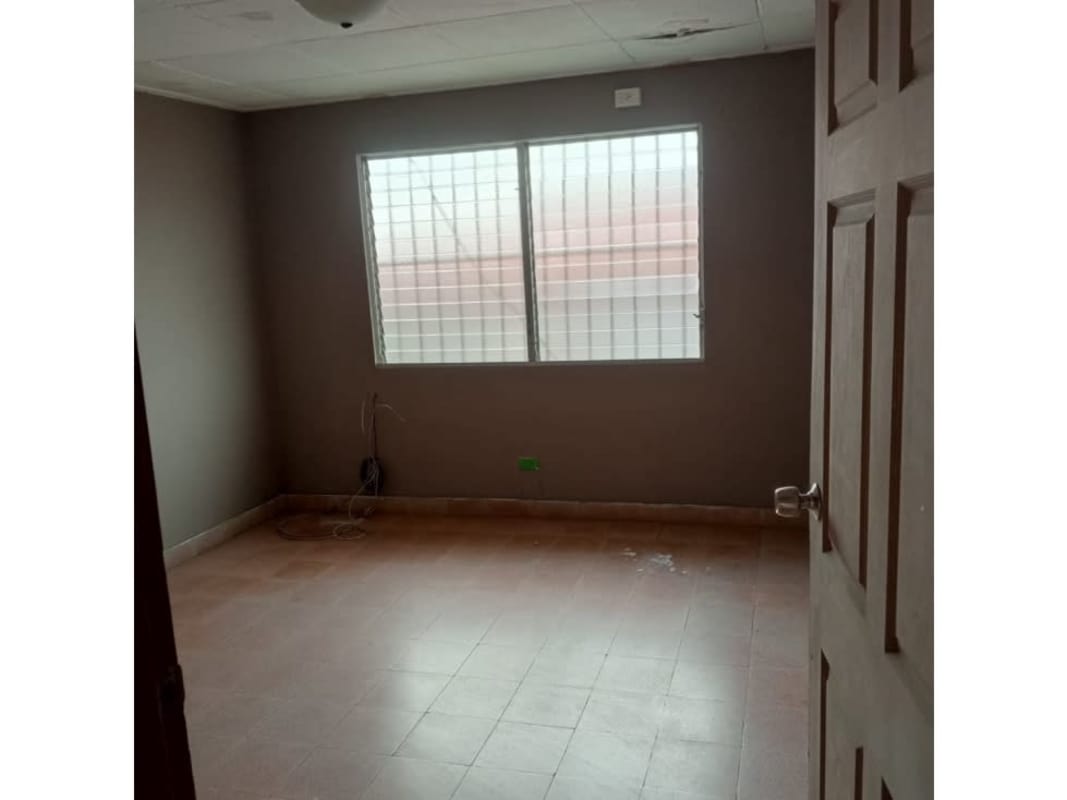 Small bathroom with blue ceramic tiles, toilet, and sink in house for rent Bethania Panama