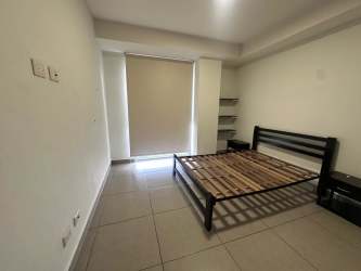 Modern bathroom with glass-enclosed shower and vanity in PH Woodlands Panama Pacifico