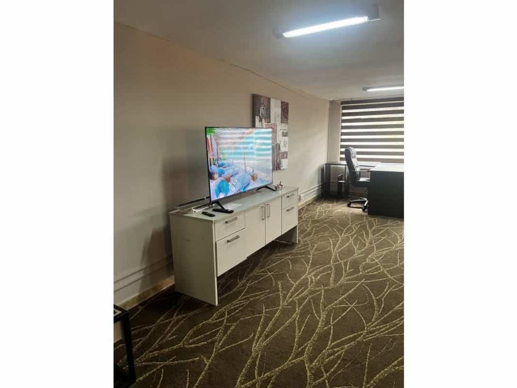 Living area with TV setup, abstract wall art PH Parque Lefevre near Parque Omar Panama