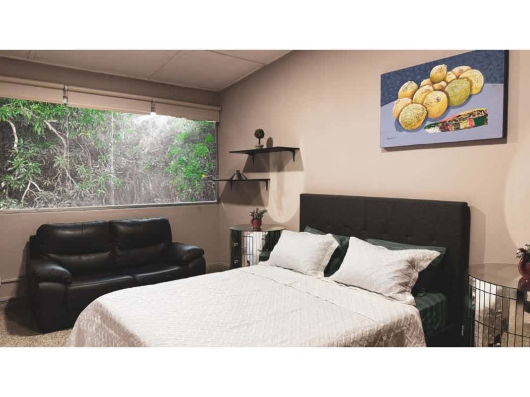 Contemporary bedroom with large garden-facing window PH Parque Lefevre Panama City