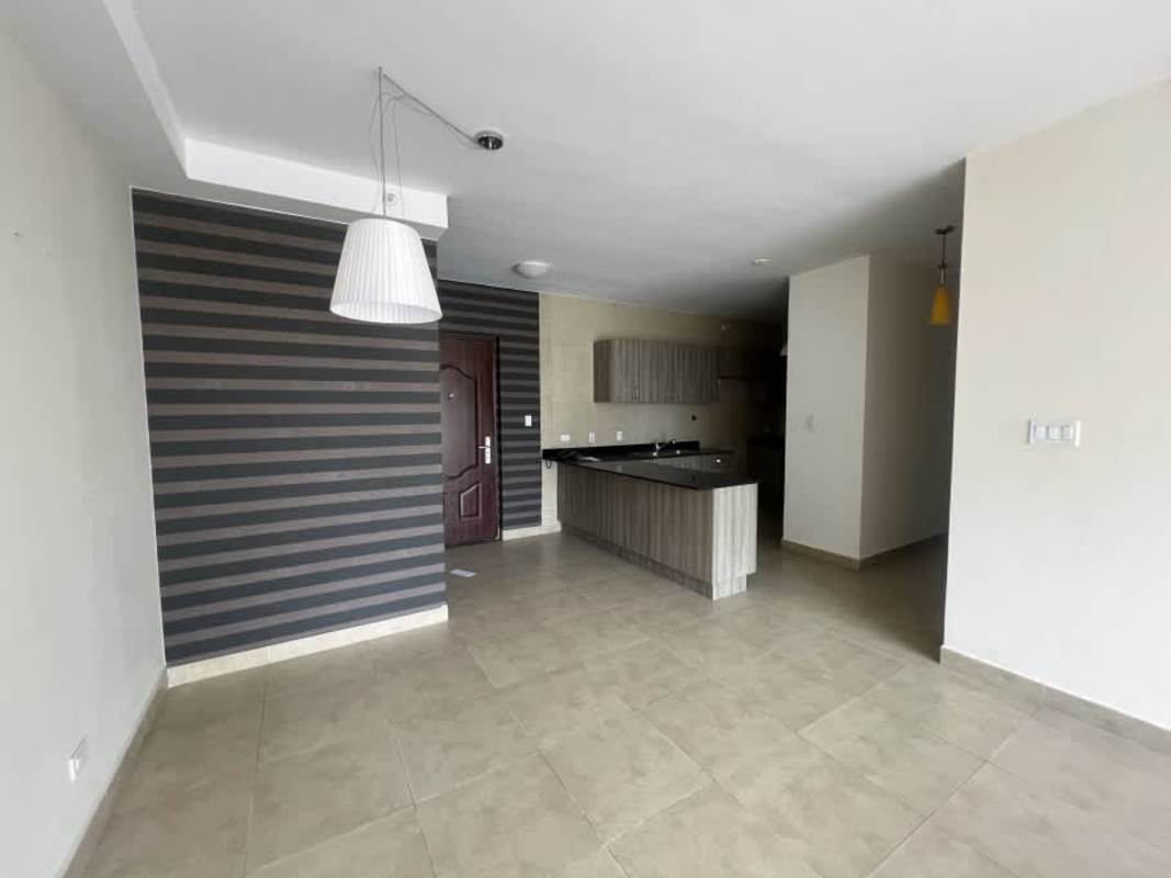 Master bedroom features terrace access, neutral colors, tile floor, and skyline view in PH The One Tower