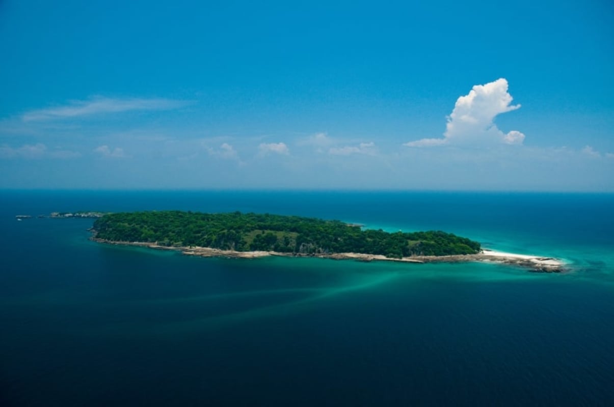 White sand beach and turquoise sea coastline on private island Punta de Bonga Las Perlas Panama