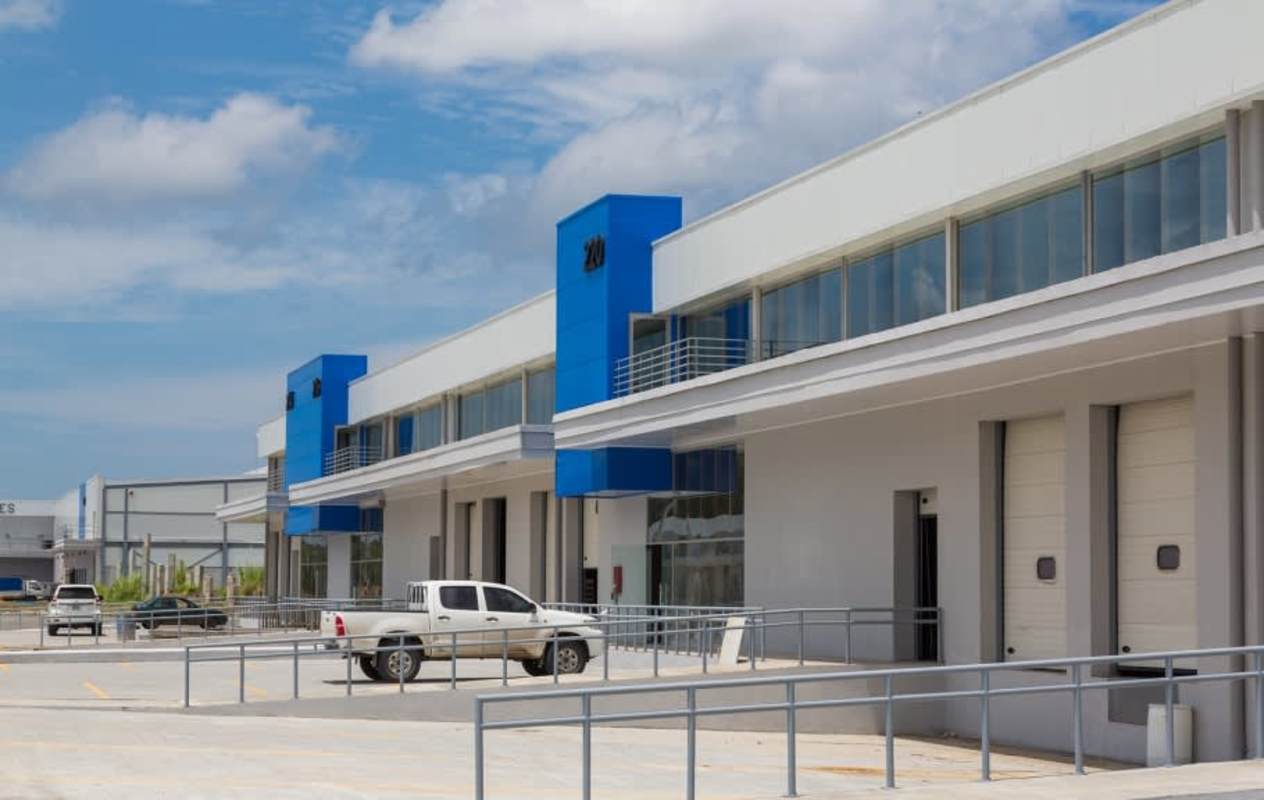Aerial view of Costa Sur industrial park roundabout with green landscape and roads Panama