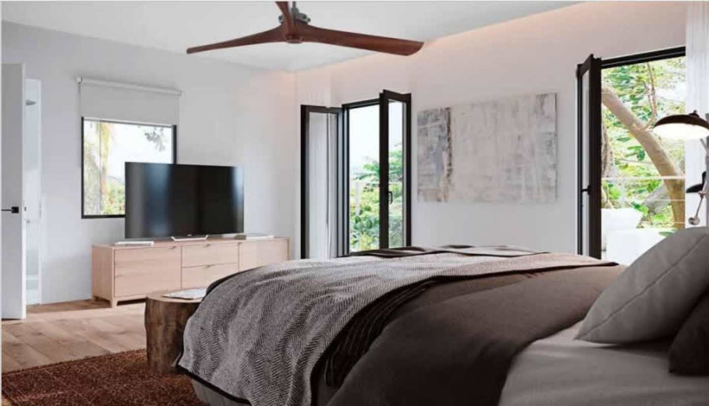 Bright bedroom with large windows, wood flooring, balcony access in Ancon house for sale Panama