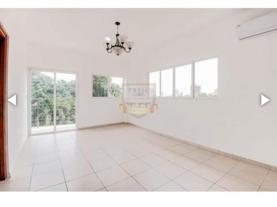 Empty living room with panoramic windows, tile floors, and balcony access Bethania Panama City