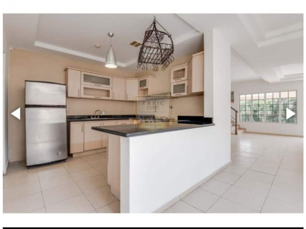 Modern U-shaped kitchen with granite countertop stainless appliances and tile floors Bethania Panama house