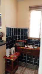 Compact tiled kitchen with refrigerator included at rental home Las Tablas