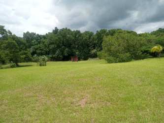 Small rustic kitchen with tiled walls and gas stove in country estate El Ciruelito Panama