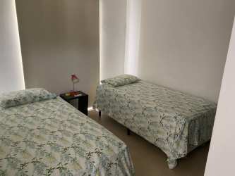 Master bedroom with queen size bed, split AC, tiled floors at Ibiza Beach Residences Panama