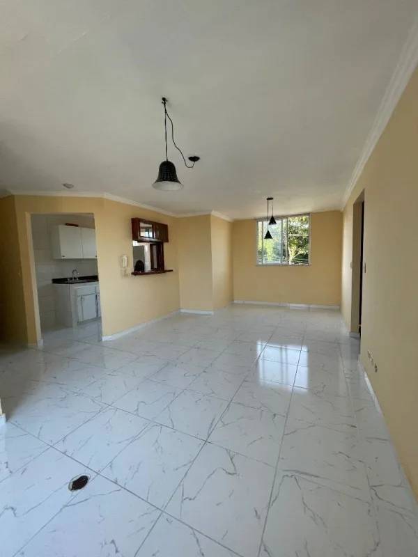 Community pool area with patio seating in Panama City apartment complex