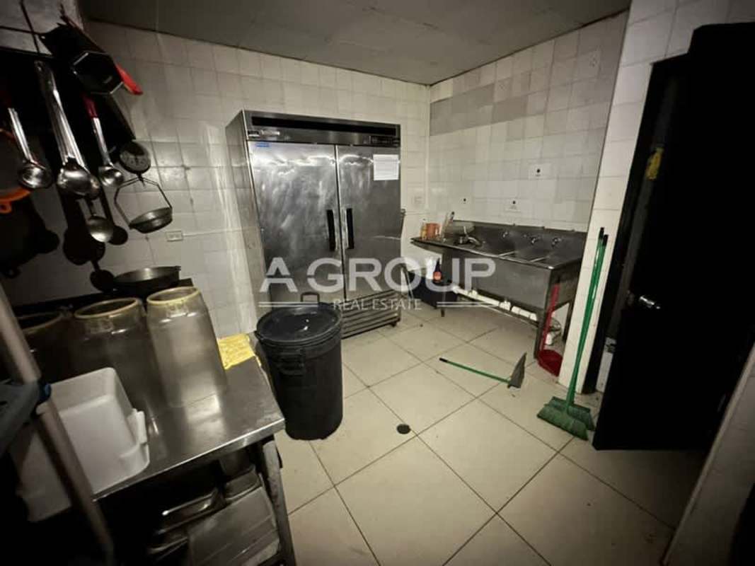 Bright restaurant dining area with orange booth seating and tiled floors in Plaza New York Panama